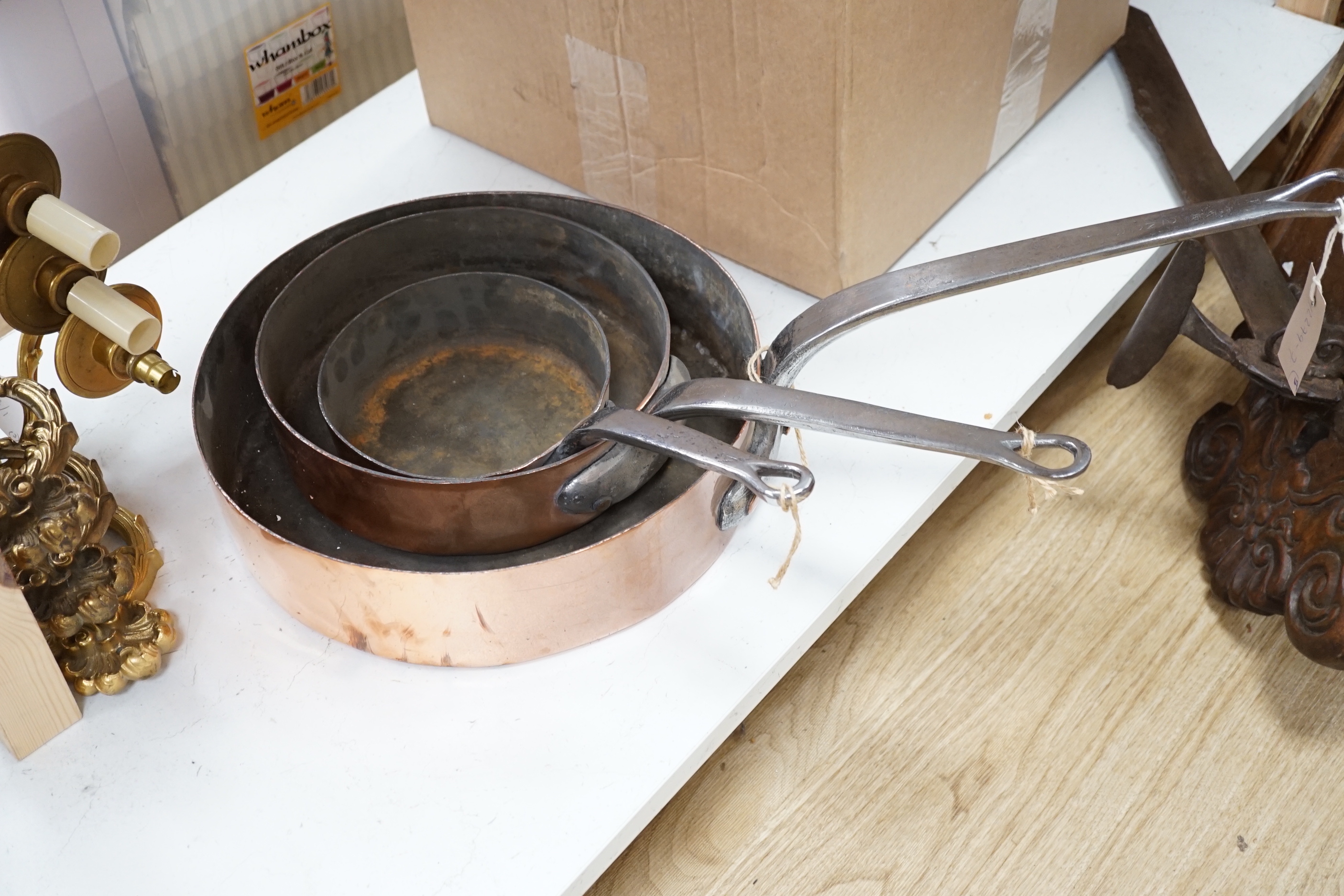 Three copper pans, largest diameter 35cm